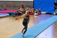Gymnast løber på 15 m  tilløbsmåtte